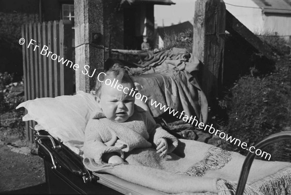 CHILD IN PRAM AT RAILWAY COTTAGES